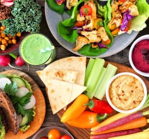 Healthy lunch table with vegetables and salad on a wooden table