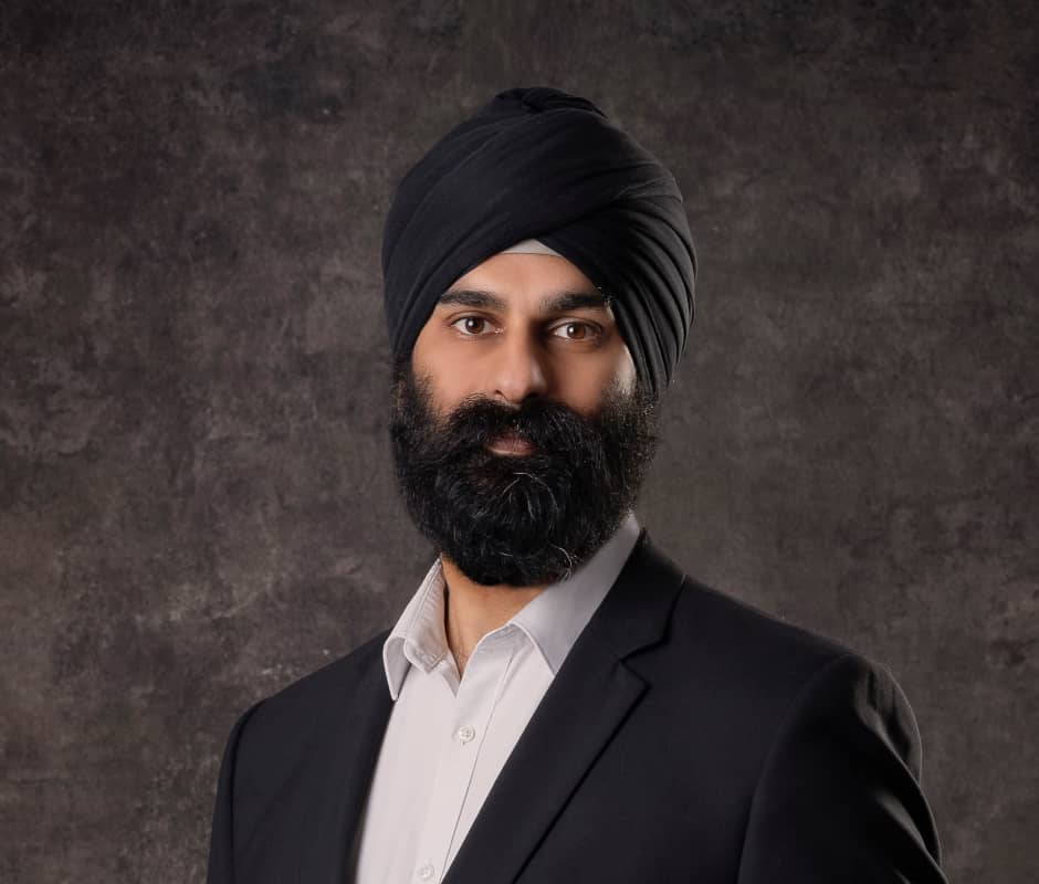 Portrait of Amandeep Dhillon on a dark brown background