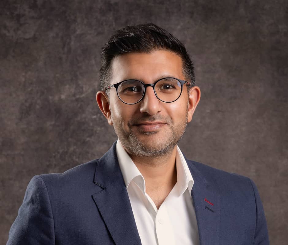 Portrait of Anand Vadgama on a dark brown background