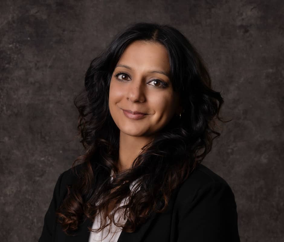 Portrait of Geeta Kumar on a dark brown background