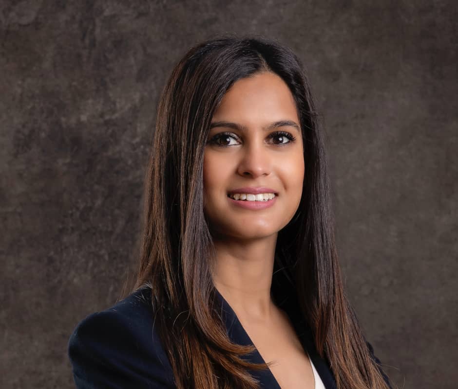 Portrait of Ridhima Patel on a dark brown background